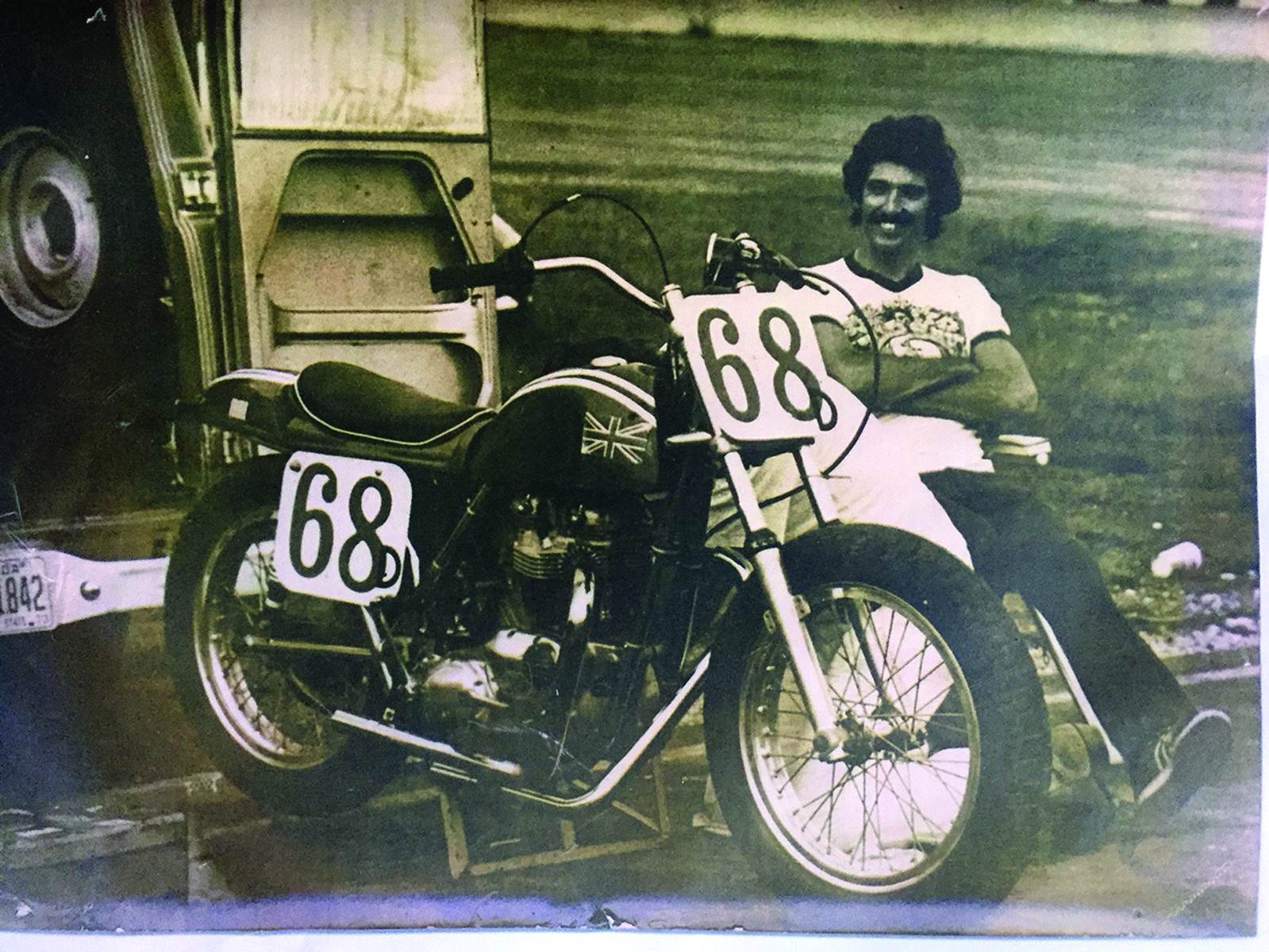 Dick Mann celebrates with a fellow racer after a motocross race. Mann